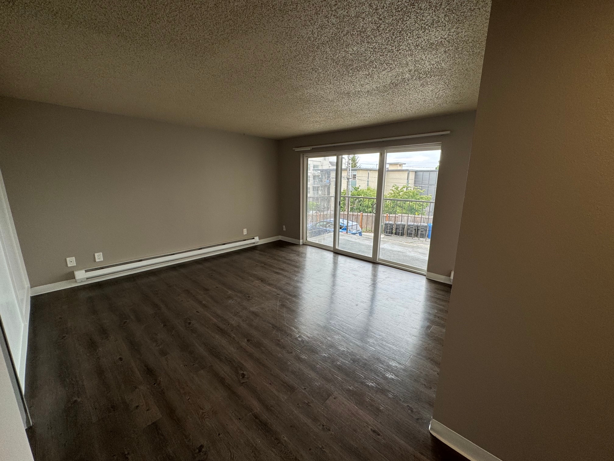 Empty residence living room with balcony doors